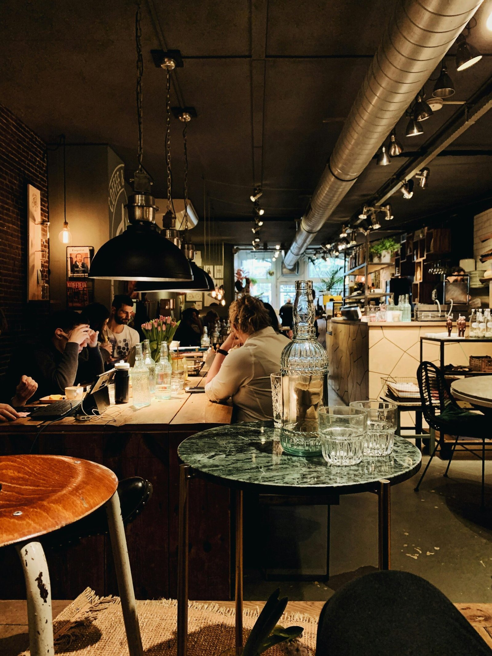 Warm and inviting modern restaurant interior with people dining and intriguing decor, perfect for lifestyle imagery.