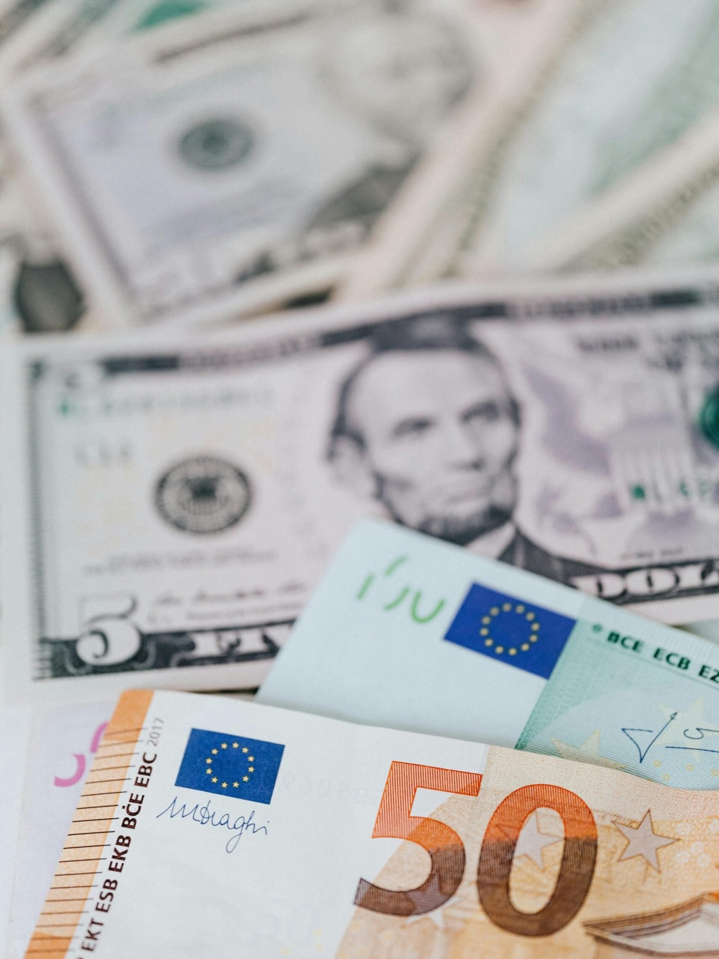 Close-up of various euro and dollar banknotes, symbolizing currency exchange and finance.